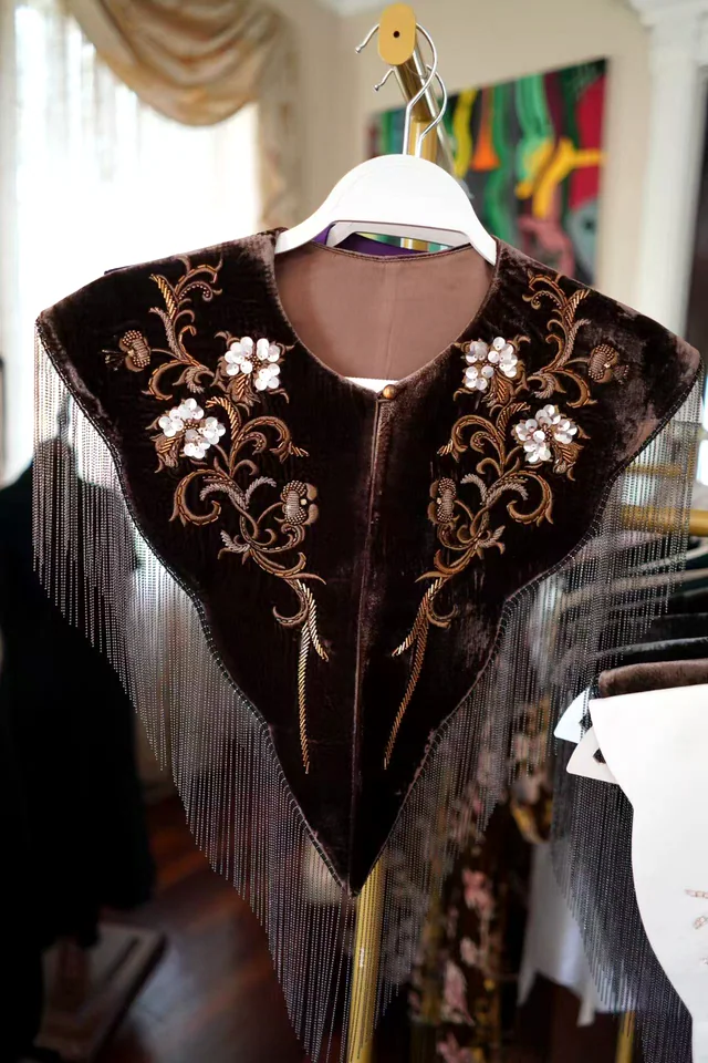 Espresso velvet beaded fringe collar displayed on a hanger